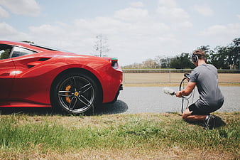 Sound Engineer Recording Red Sports Car on Racetrack