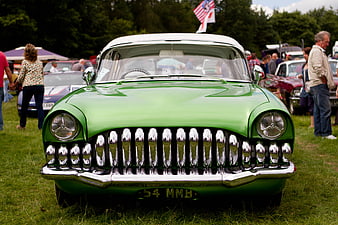 Front view of classic green vintage car at outdoor show