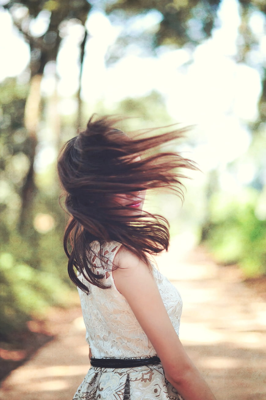 Woman with Windblown Hair in White Lace Dress