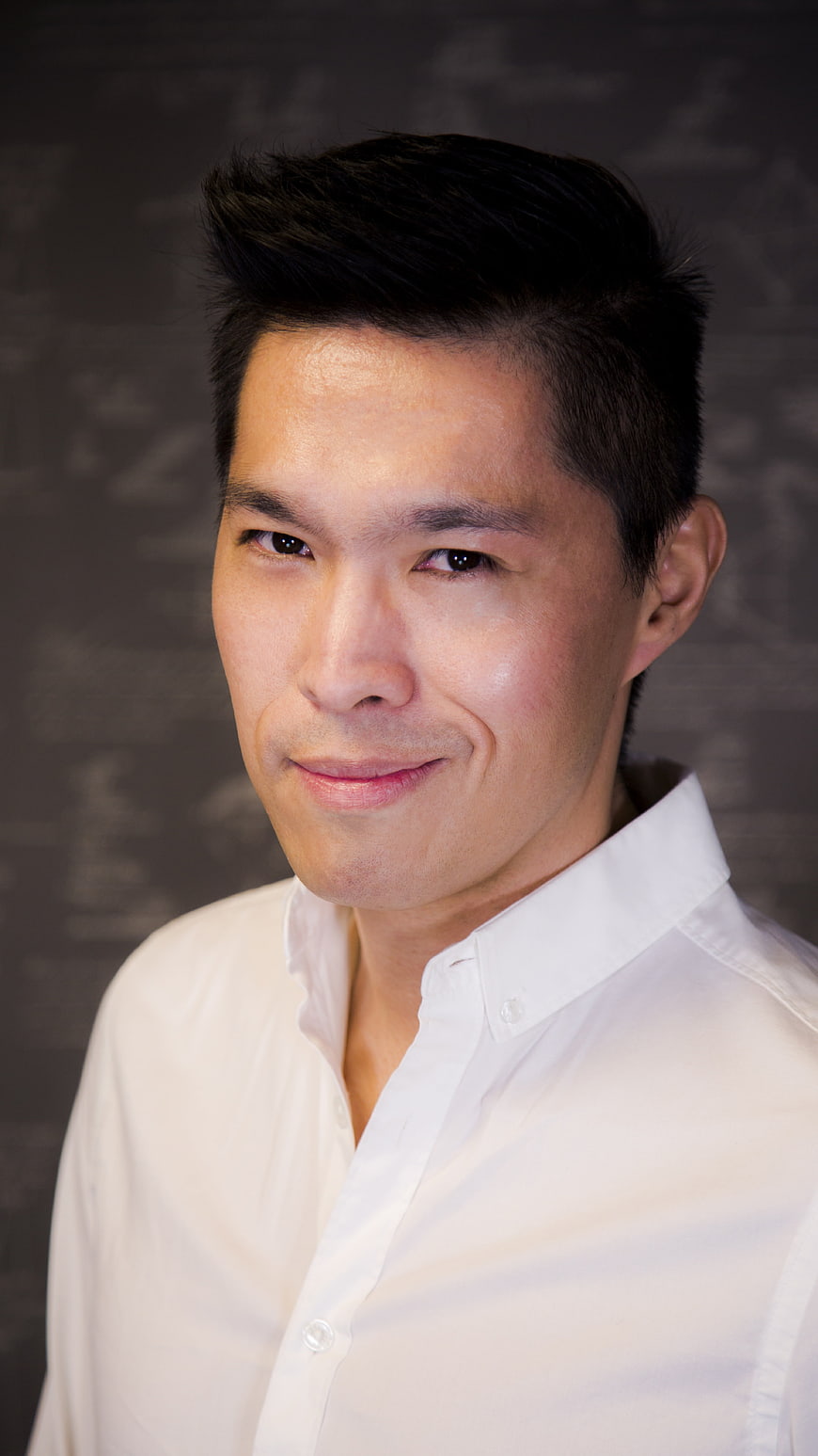 Portrait of Asian man in white shirt smiling