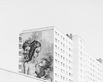 Black and white mural of mother and children on building