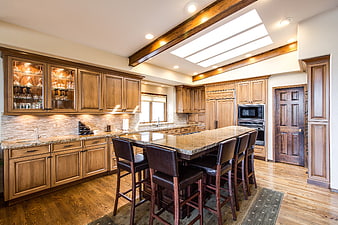 Luxury Kitchen Interior With Wooden Cabinets And Granite Island
