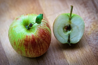 Fresh Red and Green Apple with Cut Half on Wooden Table
