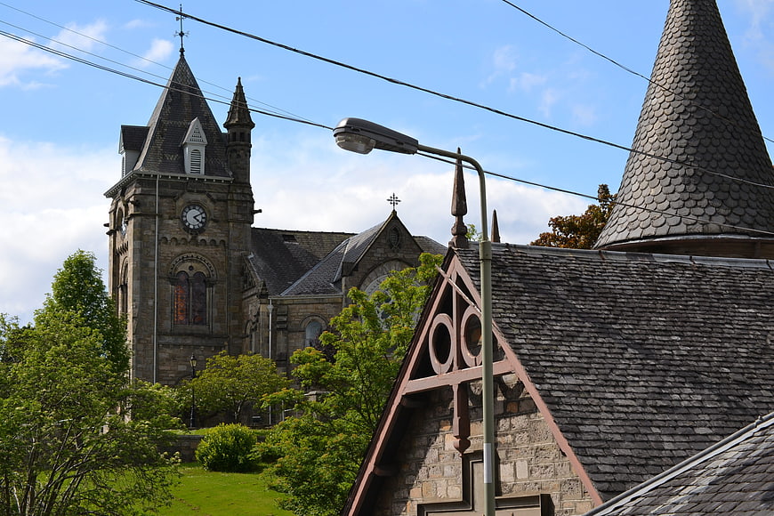 Historic stone church with clock tower and slate roof