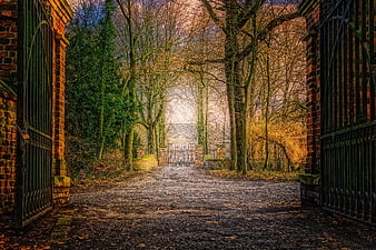 Mystical Autumn Path Leading To Historic Villa Through Iron Gates