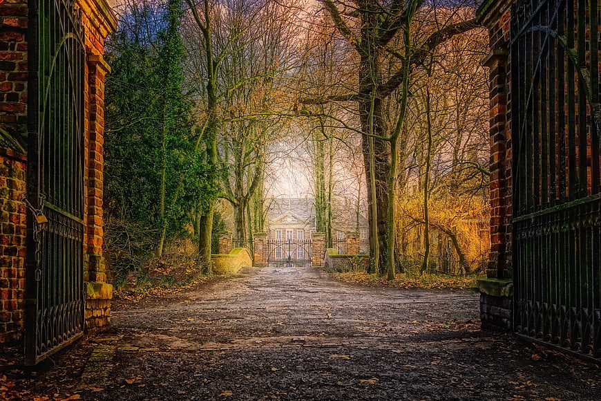 Mystical Autumn Path Leading To Historic Villa Through Iron Gates