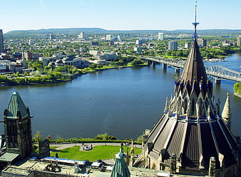Ottawa Parliament Spire Overlooking The Ottawa River And City Skyline