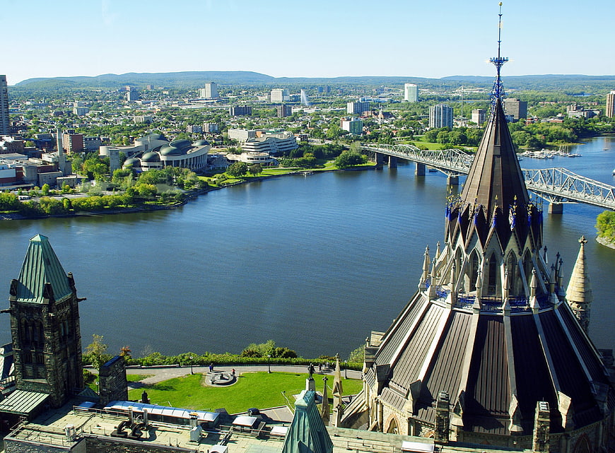 Ottawa Parliament Spire Overlooking The Ottawa River And City Skyline