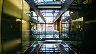 Modern glass atrium with geometric architecture and reflections