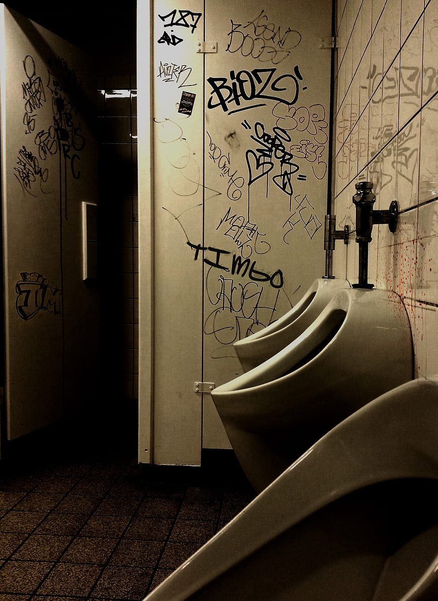 Gritty Public Men's Restroom with Graffiti and Urinals