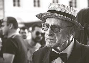 Portrait of elderly man in straw hat and bow tie