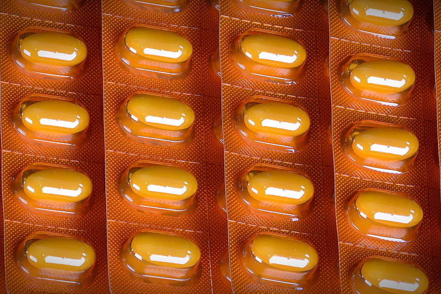 Close-up of yellow capsules in orange blister pack