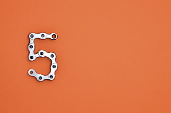 Number 5 Made Of Metal Bicycle Chain Links On Orange Background