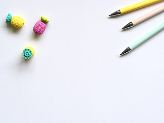 Pastel Pineapple Erasers and Pens on White Background