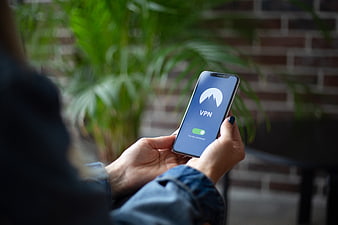 Hands holding smartphone with VPN app interface