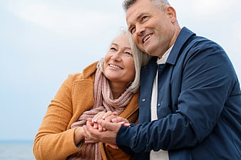 Happy Senior Couple Holding Hands Outdoors