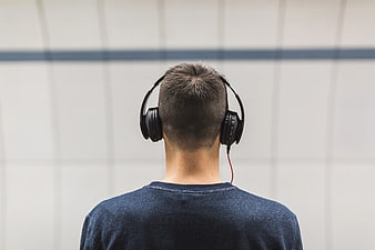 Back View of Man Wearing Headphones Listening to Music