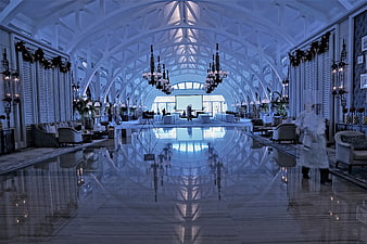 Luxurious Hotel Lobby Interior With Polished Floor Reflections And Chandeliers