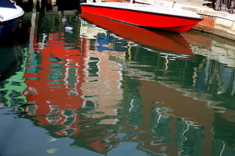 Red boat reflection in Burano canal water