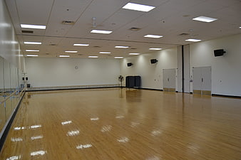 Empty Dance Studio with Wooden Floors and Mirrors
