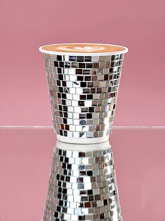 Latte Art in Silver Mosaic Cup on Pink Background