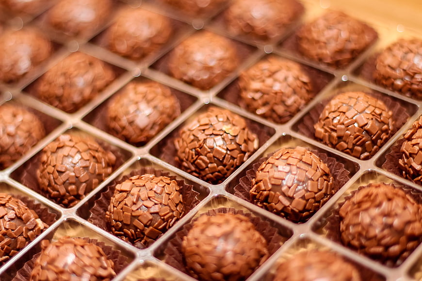 Close-up of chocolate truffles in a gold box