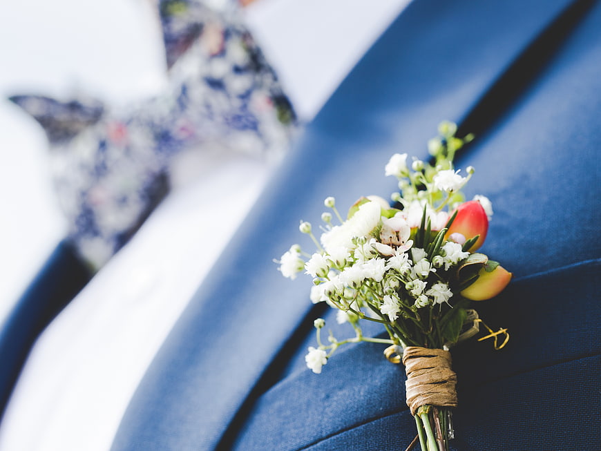 Close-up of wedding boutonniere on blue suit lapel