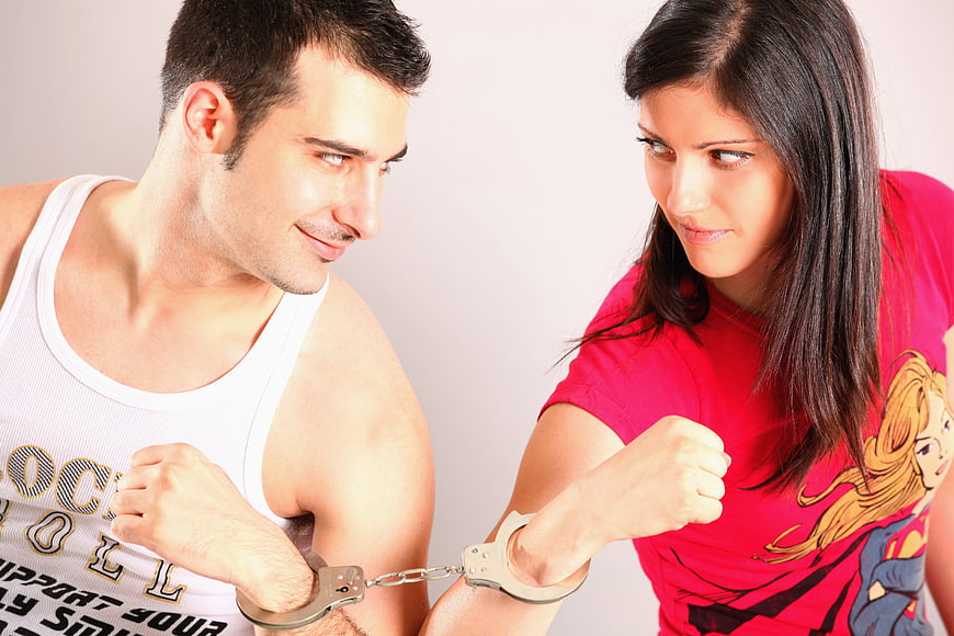 Couple handcuffed together in playful confrontation