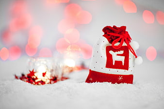 Festive Christmas Gift Bag in Snow with Bokeh Lights