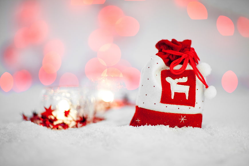 Festive Christmas Gift Bag in Snow with Bokeh Lights