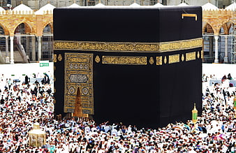 Kaaba in Mecca with large crowd of Muslim pilgrims during Hajj
