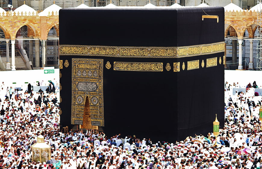 Kaaba in Mecca with large crowd of Muslim pilgrims during Hajj