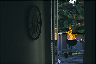 Grill Fire on Deck Viewed Through Glass Door