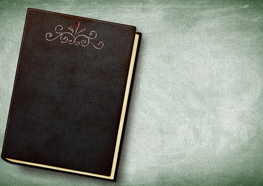 Vintage Brown Leather Book With Embossed Floral Design On Textured Background