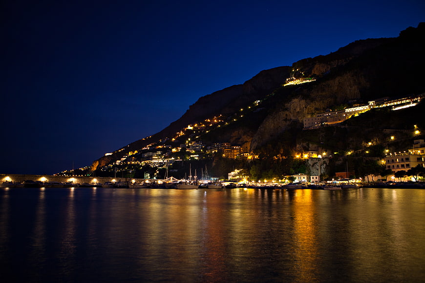 Amalfi Coast Night View with Boats and Cliff Lights