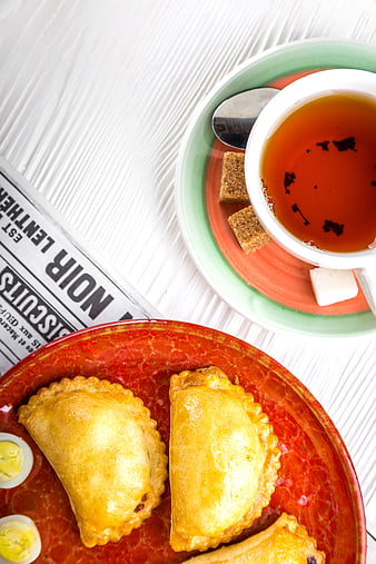 Top View of Empanadas and Tea on Rustic White Wooden Table