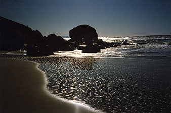 Sunlit Rocky Beach Seascape with Glowing Water