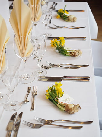 Elegant Table Setting with Daffodils and Silver Flatware