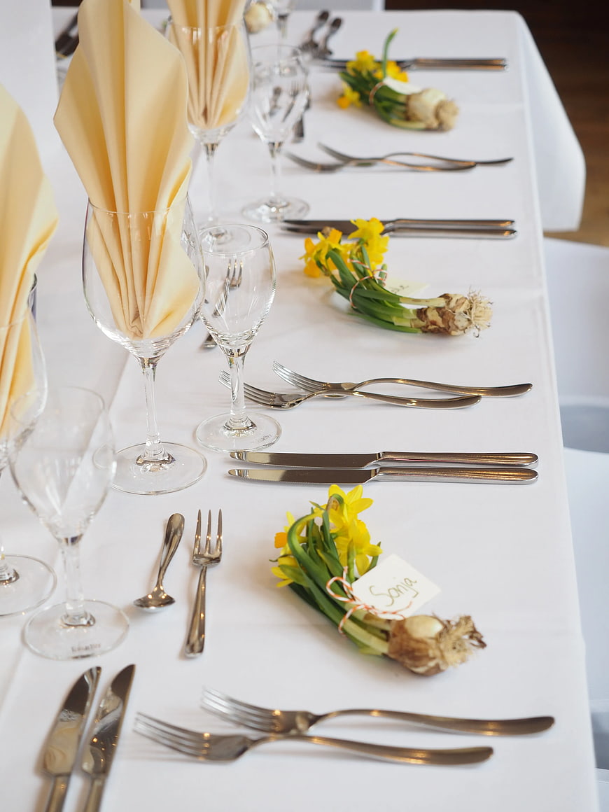 Elegant Table Setting with Daffodils and Silver Flatware