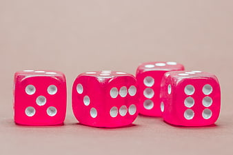 Pink translucent dice on beige background
