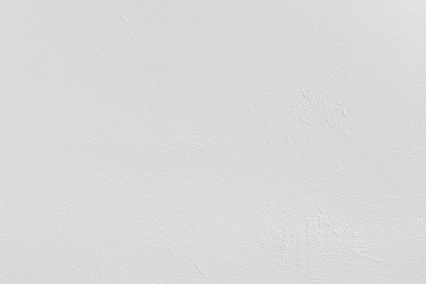 White textured wall background with subtle plaster details
