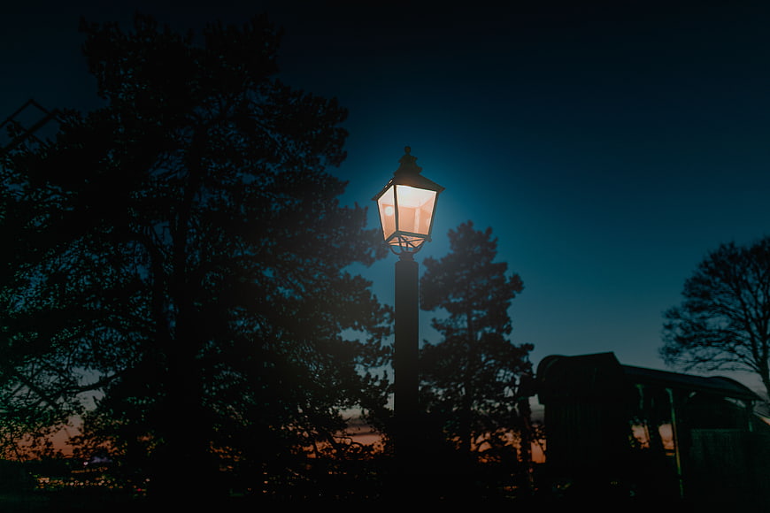 Glowing vintage street lamp against twilight sky