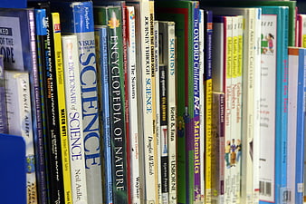Close-up of science and mathematics books on a library shelf
