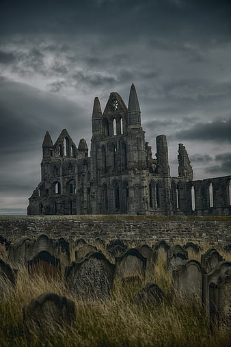 Whitby Abbey Ruins and Graveyard Under Stormy Sky