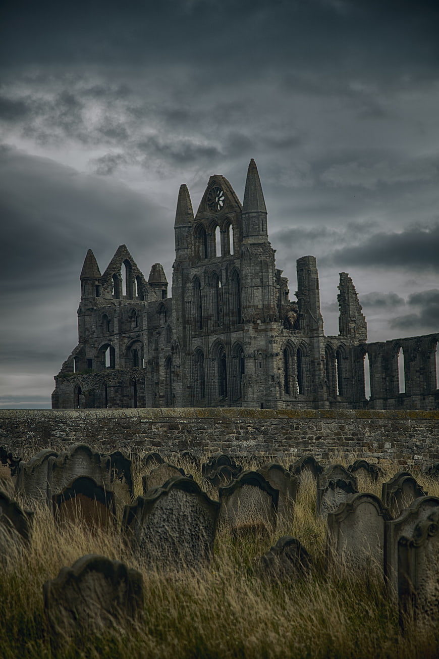 Whitby Abbey Ruins and Graveyard Under Stormy Sky