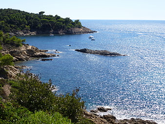 Scenic Mediterranean Coastline with Sparkling Blue Sea and Rocky Cliffs