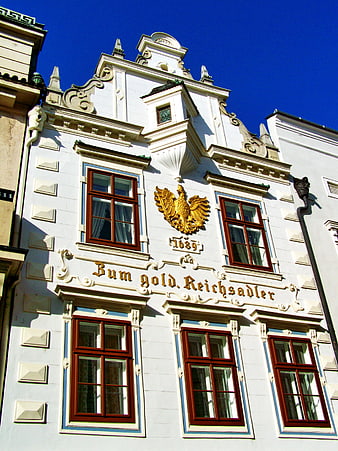 Historic Baroque Building Facade with Golden Eagle Emblem