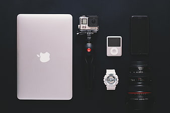 Flat lay of photography gear and tech gadgets on black background