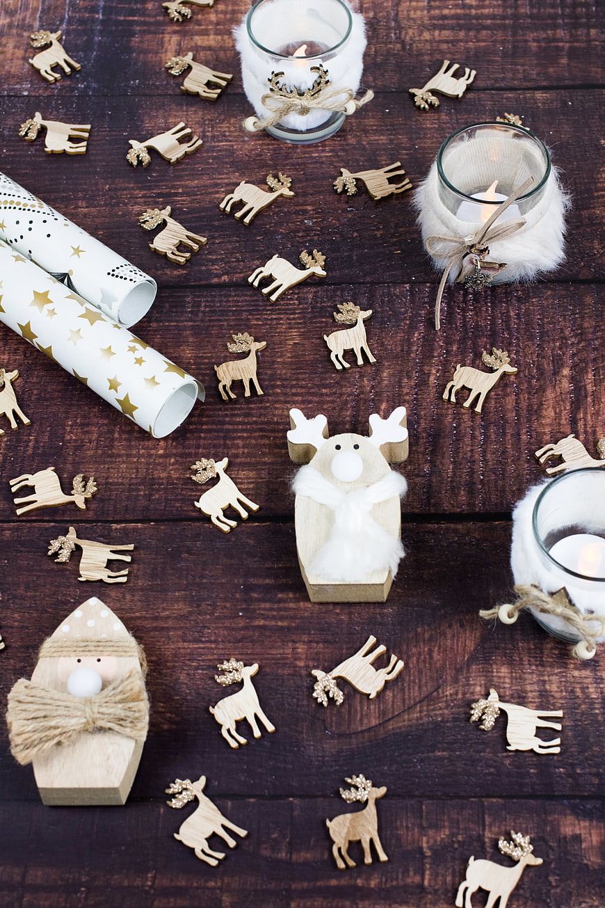 Rustic Christmas flat lay with wooden reindeer and candles