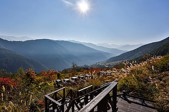 Wooden Walkway Overlooking Misty Mountain Valley in Autumn